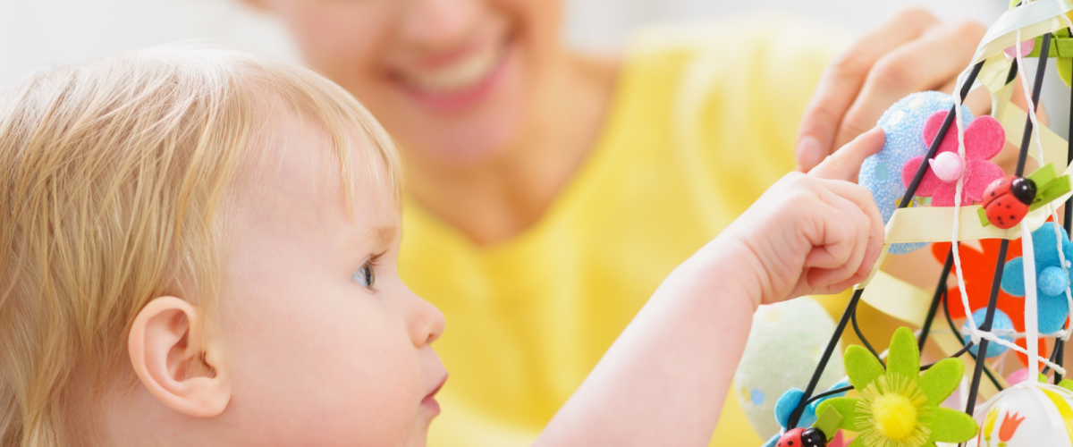 Childcare provider helping toddler learn through play